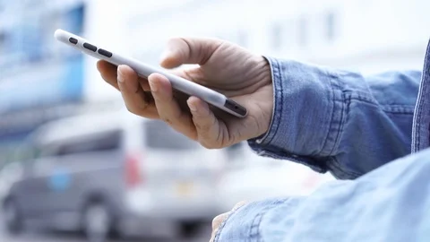 Asian man using smartphone with blurred city street Video stock 121604883