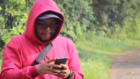 Asian man using a smartphone outdoors Stock Footage 337275491