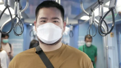 Asian man using smartphone while in public subway transportation Stock Footage 173445490