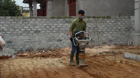 Asian man using soil compacto Stock Footage 49699038