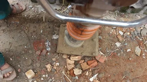 Asian man using soil compacto Stock Footage 49699067