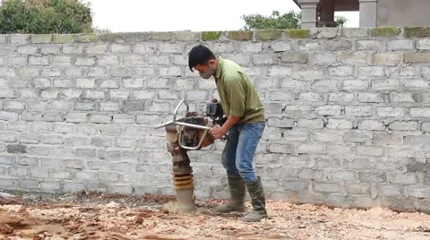 Asian man using soil compacto Video stock 49699101