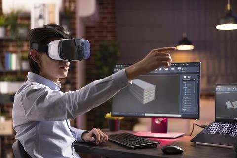 Asian man using vr headset and working remotely on 3d container model Stock Photos