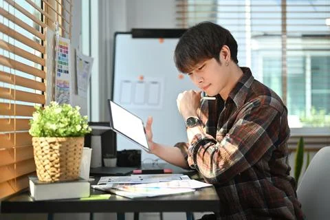 Asian man Ux developer planning application development for web mobile phone at Stock Photos