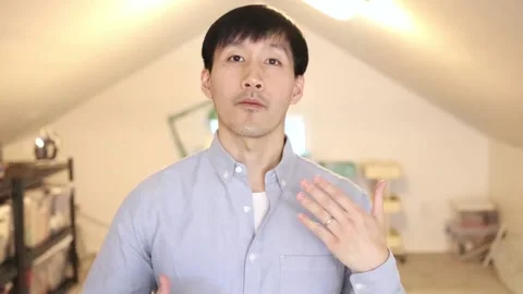 Asian Man in a video call explaining and gesturing with hands Stock-Footage 165128182
