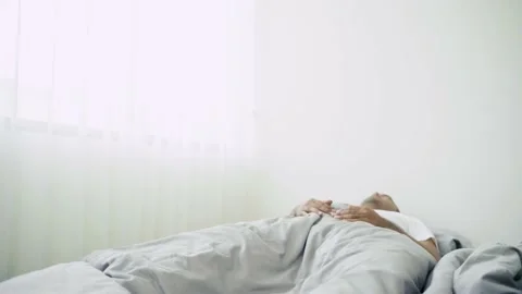 Asian man wake up while sleeping and get headache. Asian sick person wake up in  Stock Footage 135295294
