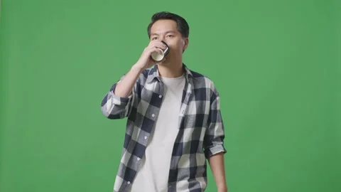 Asian Man Walking And Drinking Coffee On Green Screen Background Stock Footage 248006320