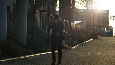 Asian man walking down road during Coronavirus pandemic Stock Footage 130343815