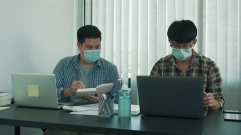 Asian man was working in a office while wearing a mask during the virus epidemic Stock Footage 149471095