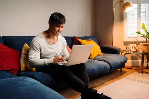 Asian man watching a program on laptop Stock Photos