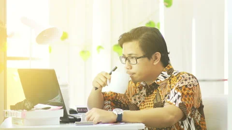Asian Man Wearing Batik Working at Office - 4K Resolution Stock Footage 60617810