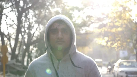 Asian man wearing a hoodie sweat shirt and jogging during dawn Stock Footage