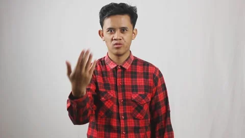 Asian man wearing red checkered shirt calls his friend Stock Footage 319923700