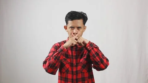 Asian man wearing red checkered shirt crossing his fingers Stock Footage 319967943