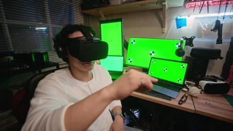 Asian Man Wearing Vr Headset Interacting with Green Screen Monitors Stock Footage 338423235