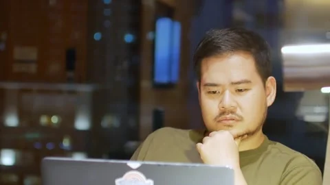 Asian man while working on laptop in night time shift Stock Footage 271616373