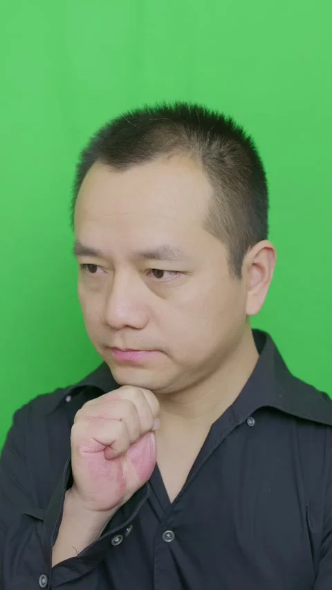An Asian man who facing problem, pinches his chin while thinking Stock Footage 321232140