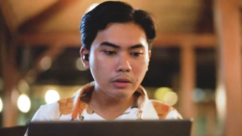 Asian man worker having video call on laptop computer in cafe indoor at night. Stock Footage 289030973