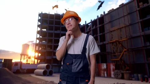 Asian Man Worker Thinking About Something At Construction Site Stock Footage 283995264