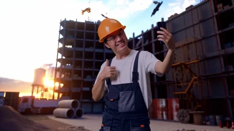 Asian Man Worker Using Smartphone Taking Picture At Construction Site Stock Footage 283995646