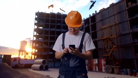 Asian Man Worker Using Smartphone At Construction Site Stock Footage 283995657