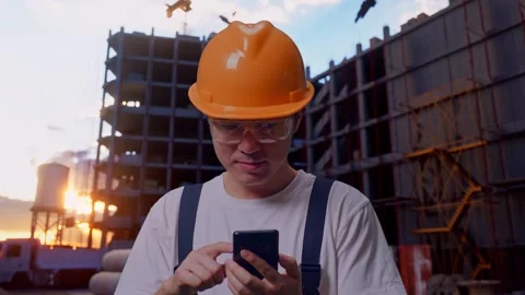 Asian Man Worker Using Smartphone At Construction Site Stock Footage 283996339