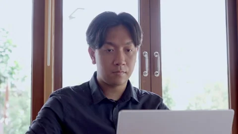 Asian man working on computer in cafe Stock Footage 310175863