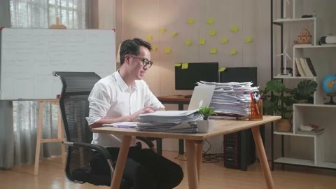 Asian Man Working With Documents At The Office Stock Footage 196115752