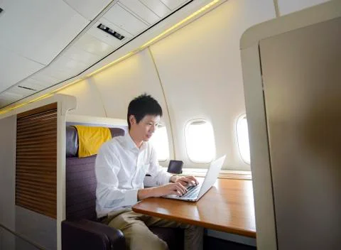 Asian man working on first class airplane Stock Photos