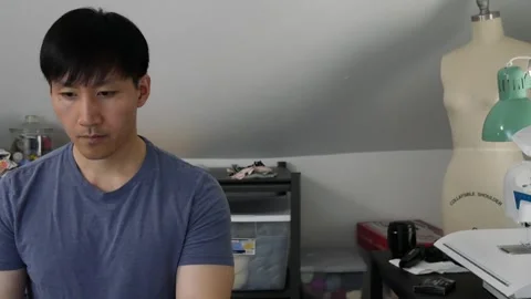 Asian man working on the left side of the screen in his craft room Видео 247874289