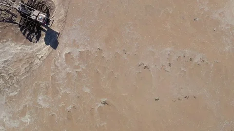 Asian man working on the rice fields with the tractor. Image taken from above Stock Footage 124636182