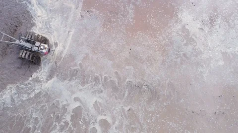 Asian man working on the rice fields with the tractor. Image taken from above Stock Footage 124636242