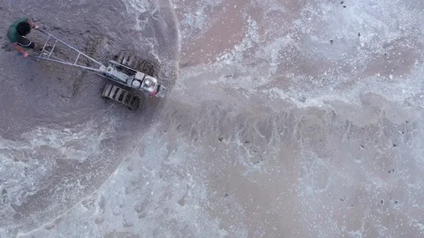Asian man working on the rice fields with the tractor. Image taken from above Stock Footage 124636252