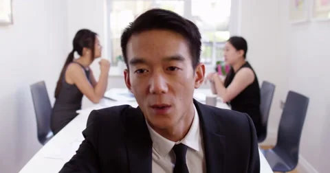 An Asian manager having a video conference from her boardroom. Shot on RED Epic. Stock Footage 58686960