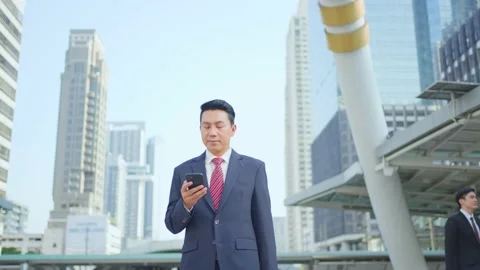 Asian manager smart businessman using smartphone in city. Stock Footage 147912739