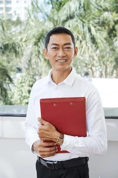Asian manager standing with folder Stock Photos