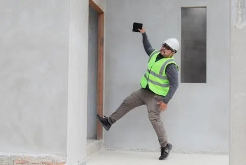Asian managers, foremen, or engineer slip on unfinished cement in site acci.. Stock Photos