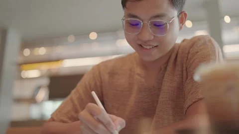 Asian man's hands doing homework on tablet, outdoor online learning concept Stock Footage 251974050