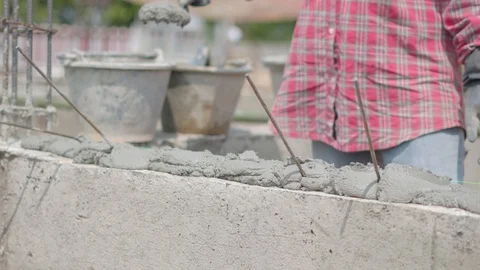 Asian masonry worker makes concrete wall at house construction site Video stock 88126004