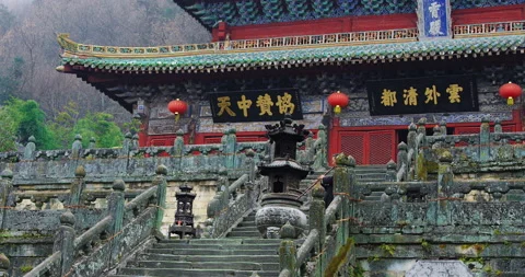 Asian master, demonstrates blowing Chinese flute in Wudang mountain China. Slow Stock Footage 201096992