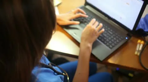 Asian Medical Assistant Enters Data, Tracking Dolly Shot Stock Footage