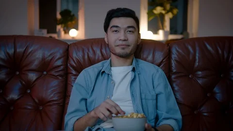 Asian men get interested while watching video. Stockbeeldmateriaal 105748212