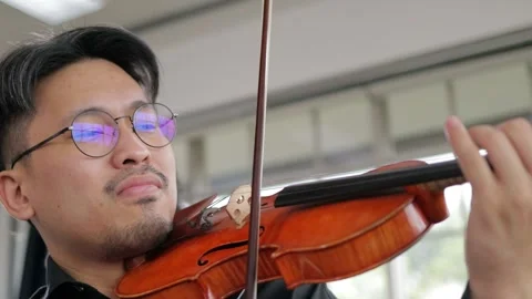 Asian men playing the violin classical instrument. Stock Footage 243591605
