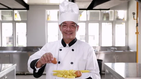 Asian middle age chef man show ingredient with camera in kitchen, hotel or .. Stock Footage 246720180