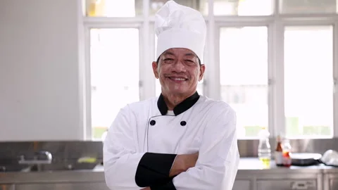 Asian middle age chef standing in front of kitchen cross arm and smiling, h.. Stock Footage 246720128