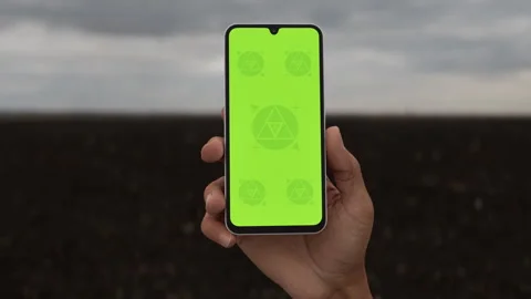 Asian middle aged male using smartphone with a blank green screen Stock Footage 293567736