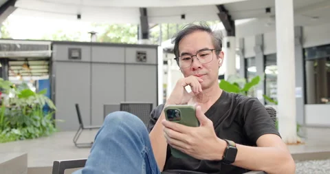 Asian Middle-aged man using smartphone to shop online. Senior make financial  Stock Footage 287843642