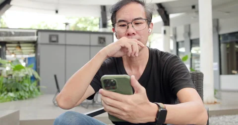 Asian Middle-aged man using smartphone to shop online. Senior make financial  Stock Footage 287843845