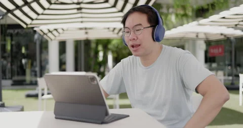 Asian middle aged man wearing glasses, headphone to video call Stock Footage 160140969