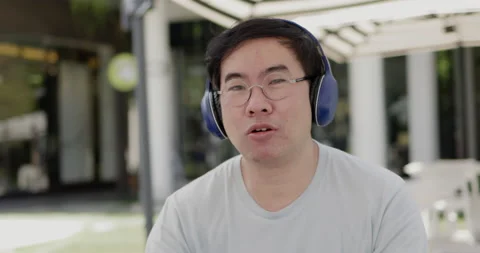 Asian middle aged man wearing glasses, headphone to video call Stock Footage 160141021
